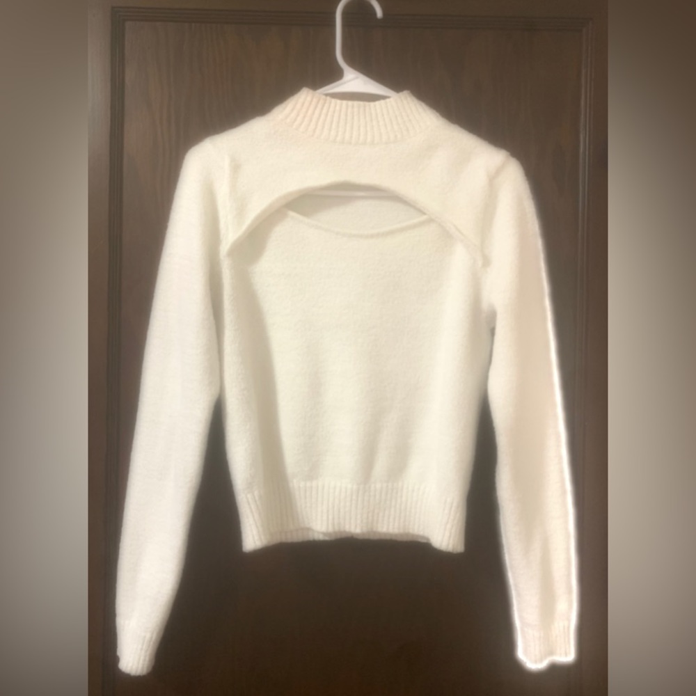 White sweater with open chest area.